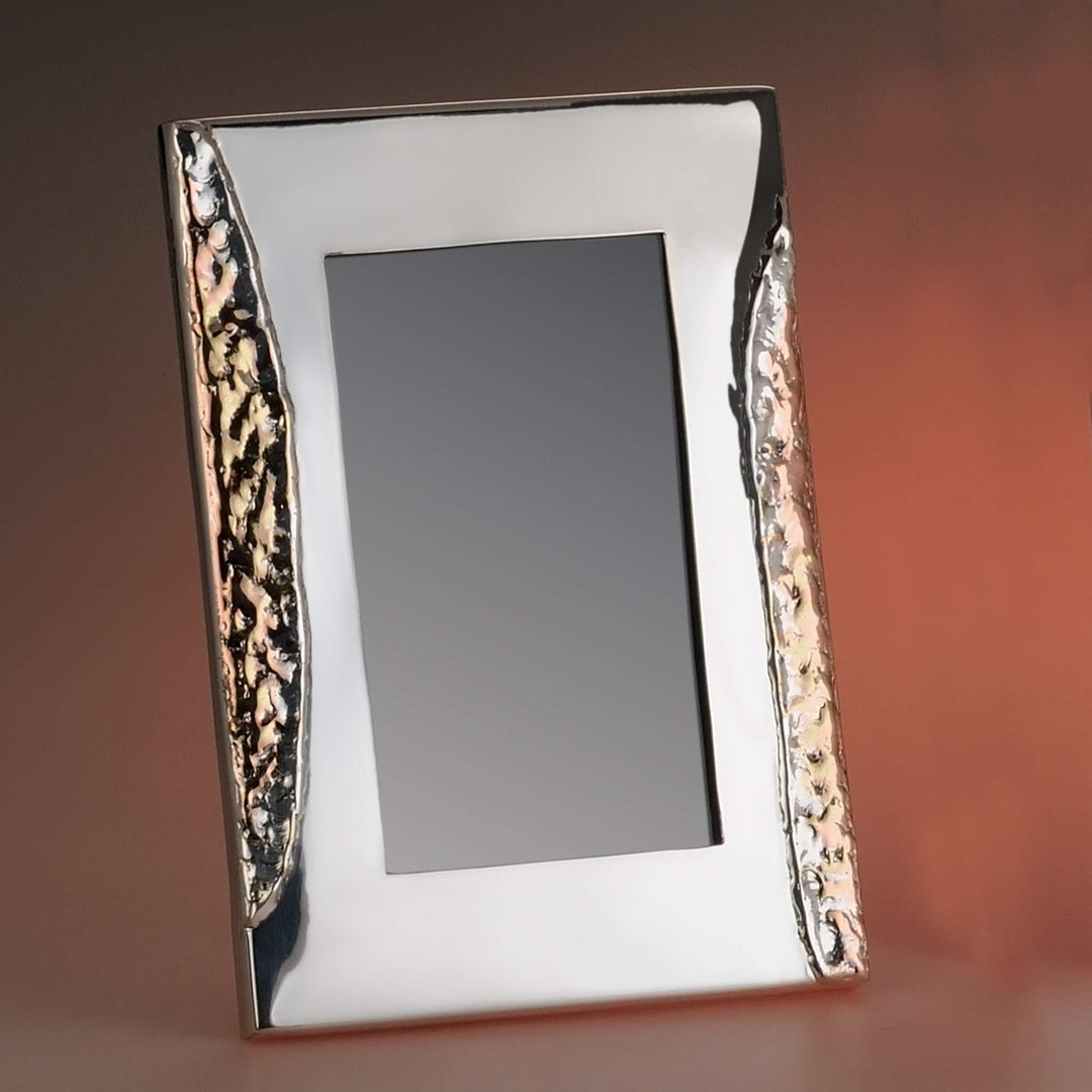 Photo Frame Desire is a silver frame that meets a mirror-polished centre with mottled, hammered-look textured bands down each side – Medium
