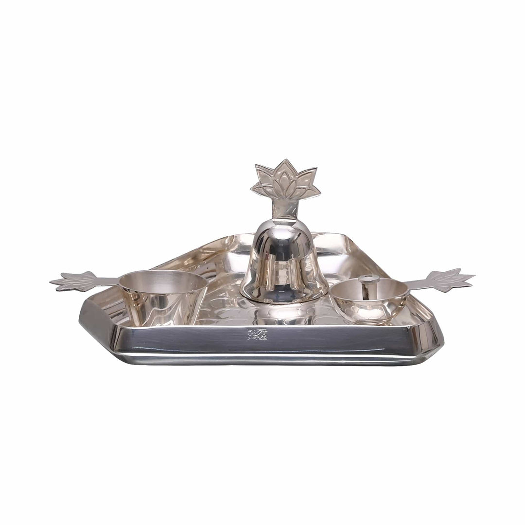Pooja Thali Diamond covers a silver pooja tray in an all-over diamond texture, fitted with a lotus-topped bell and two small bowls - white background