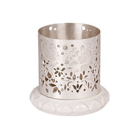 Flower Votive is a silver votive wrapped in a row of layered petals around its base, each cut opening - white background