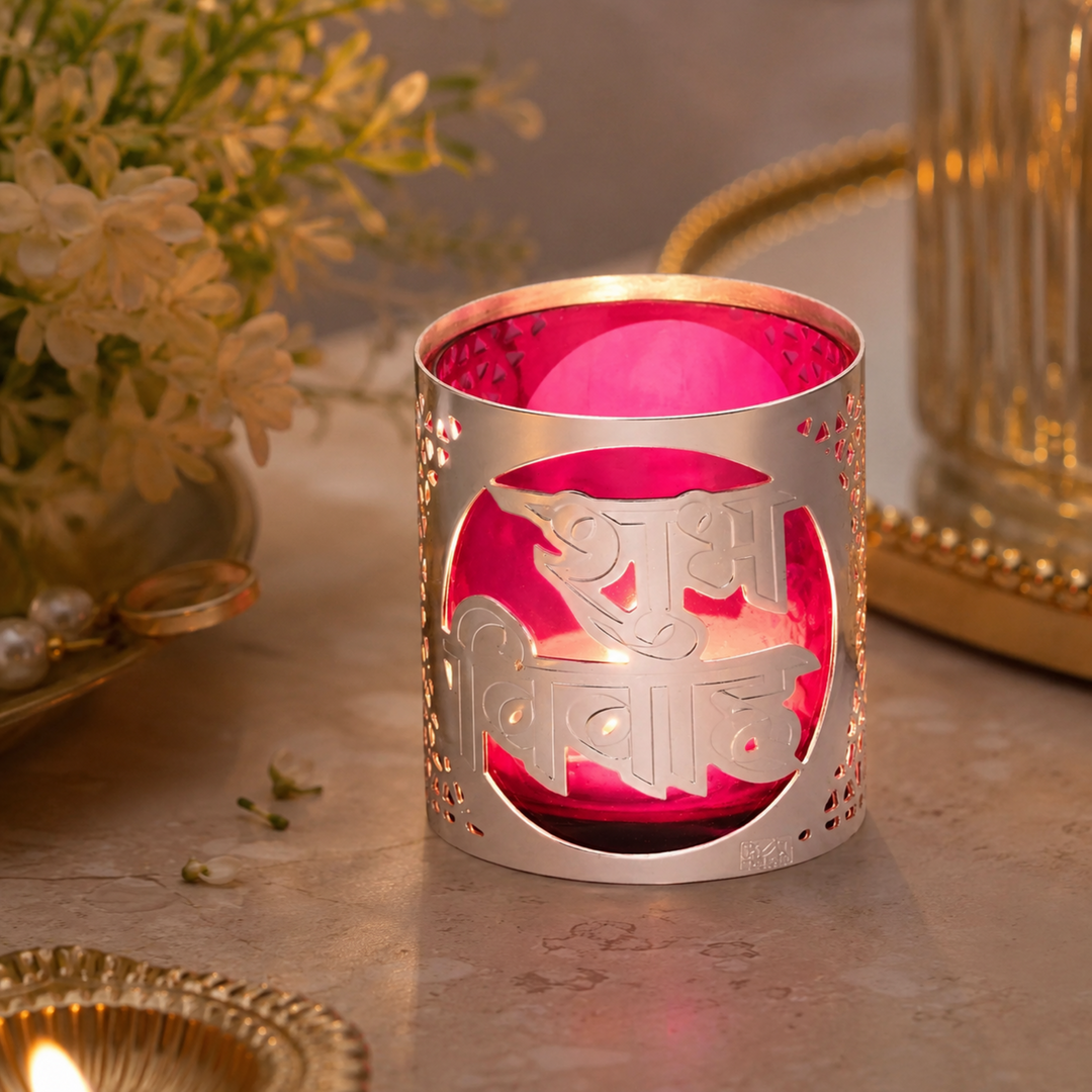 Glimmer Shubh Votive is a silver votive with a brass shell paired with a coloured glass insert in pink - angle 4