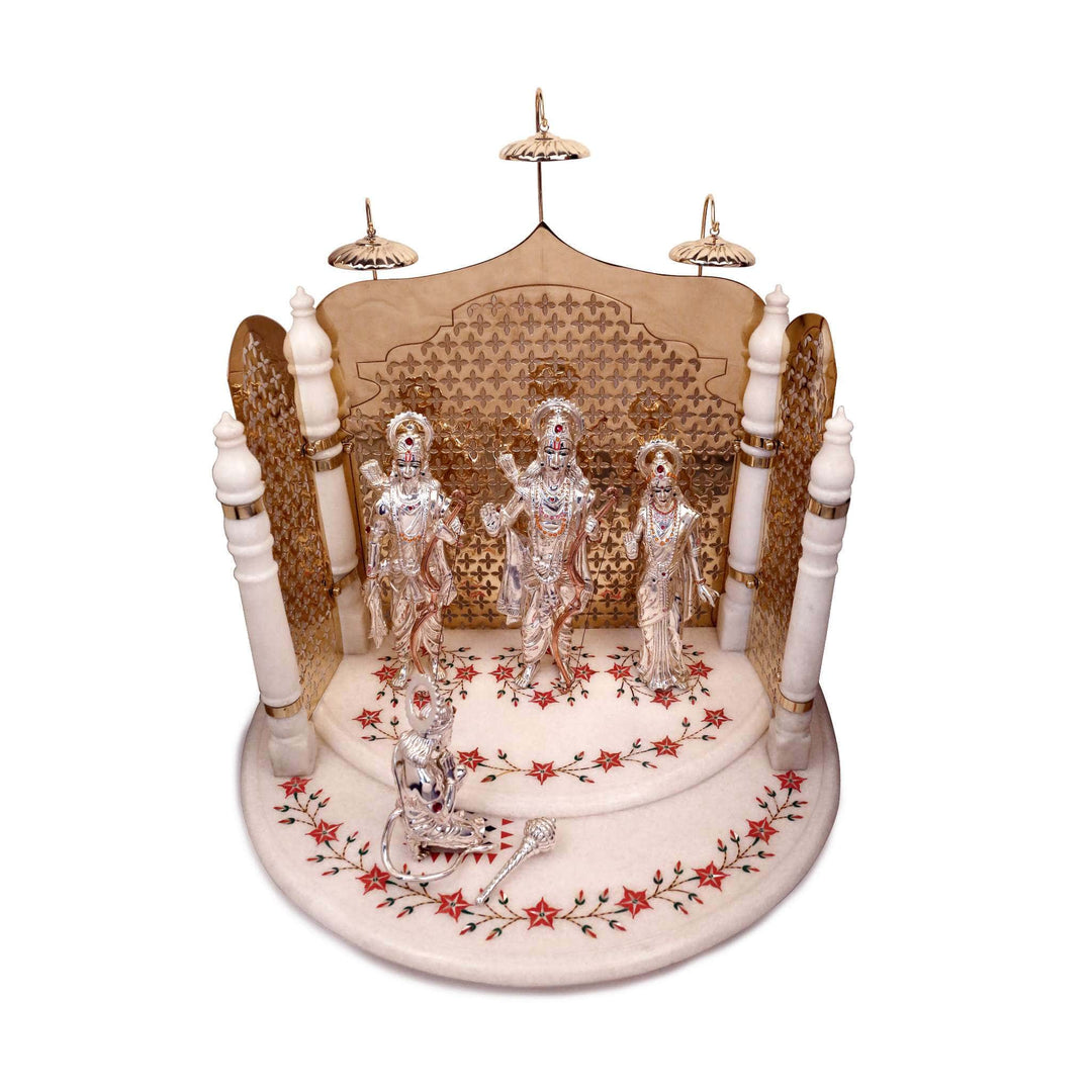 Ram Mandir Ram Darbar is a mandir formed by a gold-toned jali screen crowned with domed chattris around sterling silver idols of Ram - white background