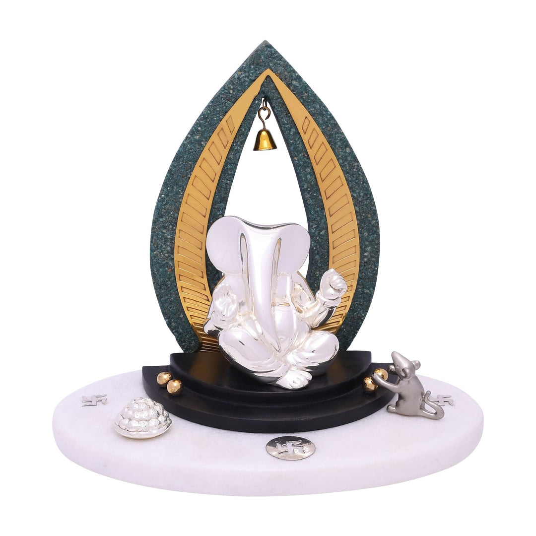 Ganesh Anaye is a sterling silver Ganesha idol seated inside a teardrop-shaped arch of gold-lined stone - white background