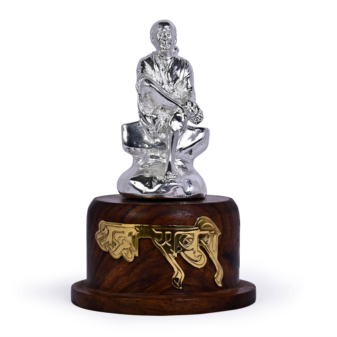 Sai Baba Anugrah is a silver idol showing Sai Baba in quiet blessing on a rosewood base - white background
