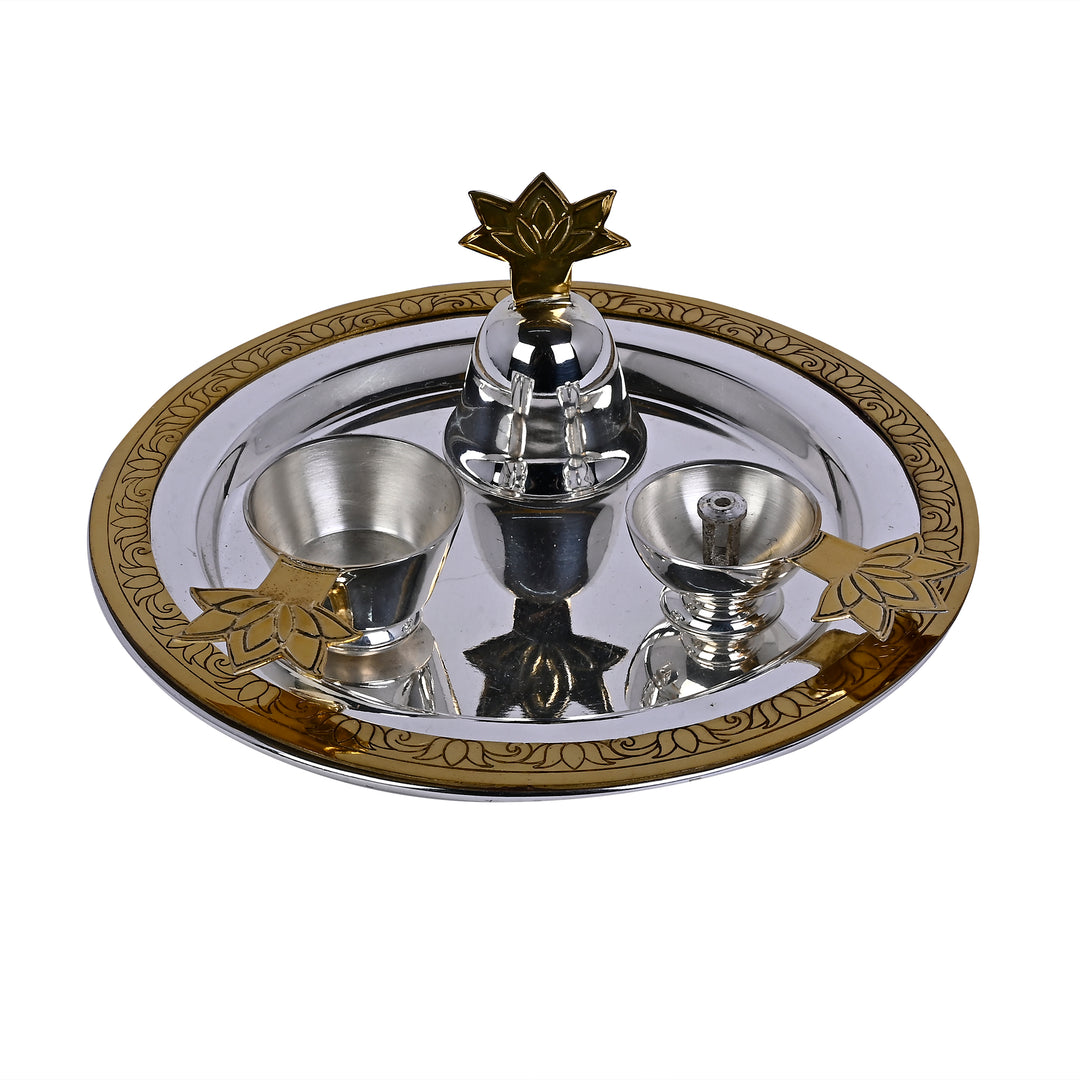 Divya Pooja Thali finishes a silver tray with a gold-toned lotus border, fitted with a small bell and two bowls for kumkum and diya oil - white background