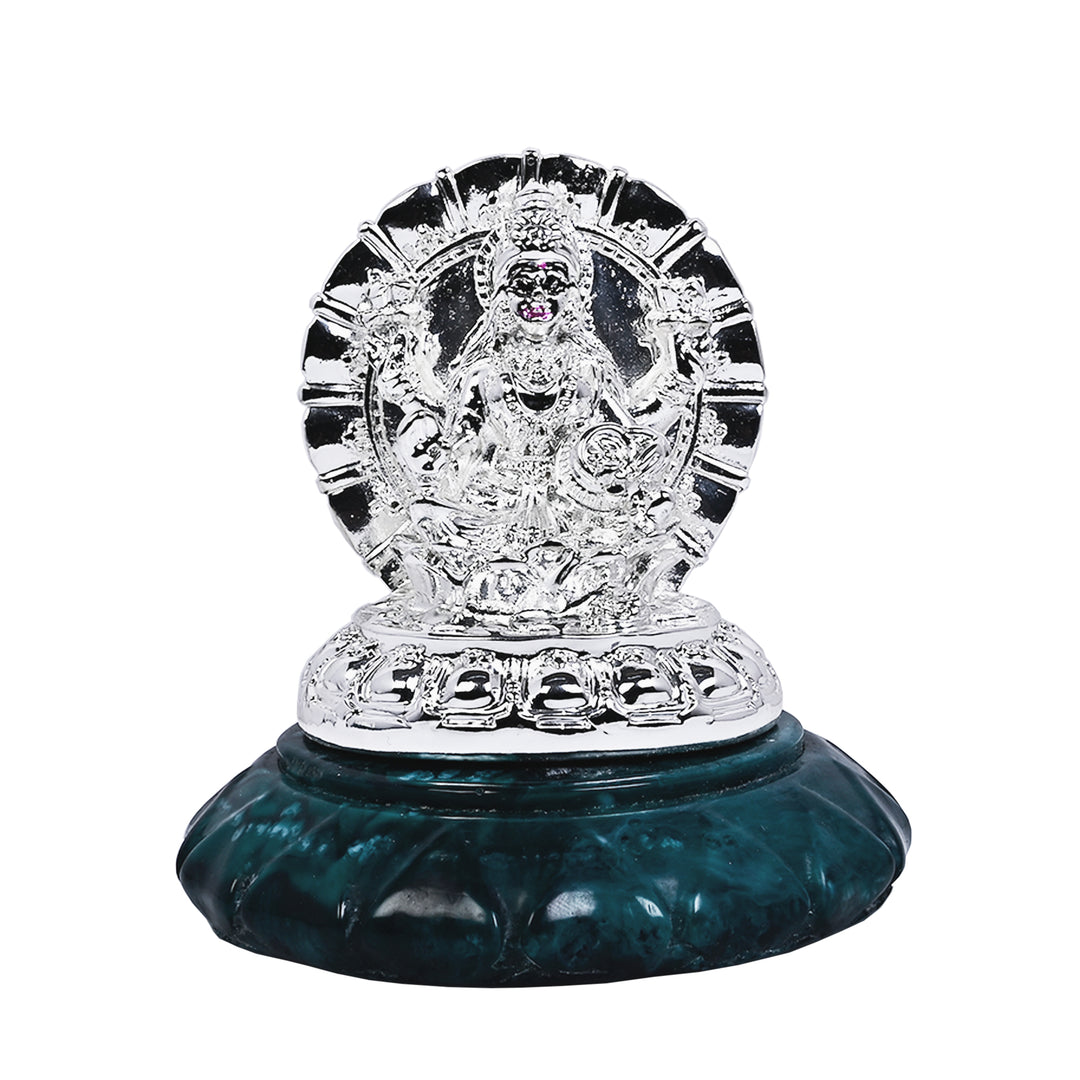 Laxmi Mangala sets a silver Lakshmi idol, seated with multiple raised hands, inside a sunburst medallion frame, mounted on a teal marbled stone base - white background