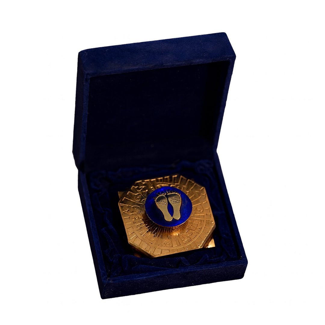 Welcome Lakshmi Feet takes the form of a sterling silver coin bearing a pair of Lakshmi&