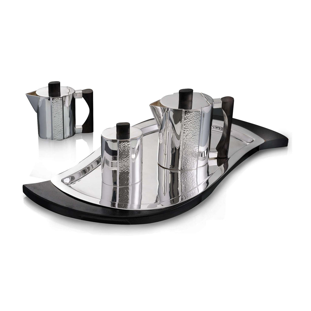 Tea Set Earl is a silver teapot set with an angular, faceted body and a vertical hammered-texture panel running down each piece