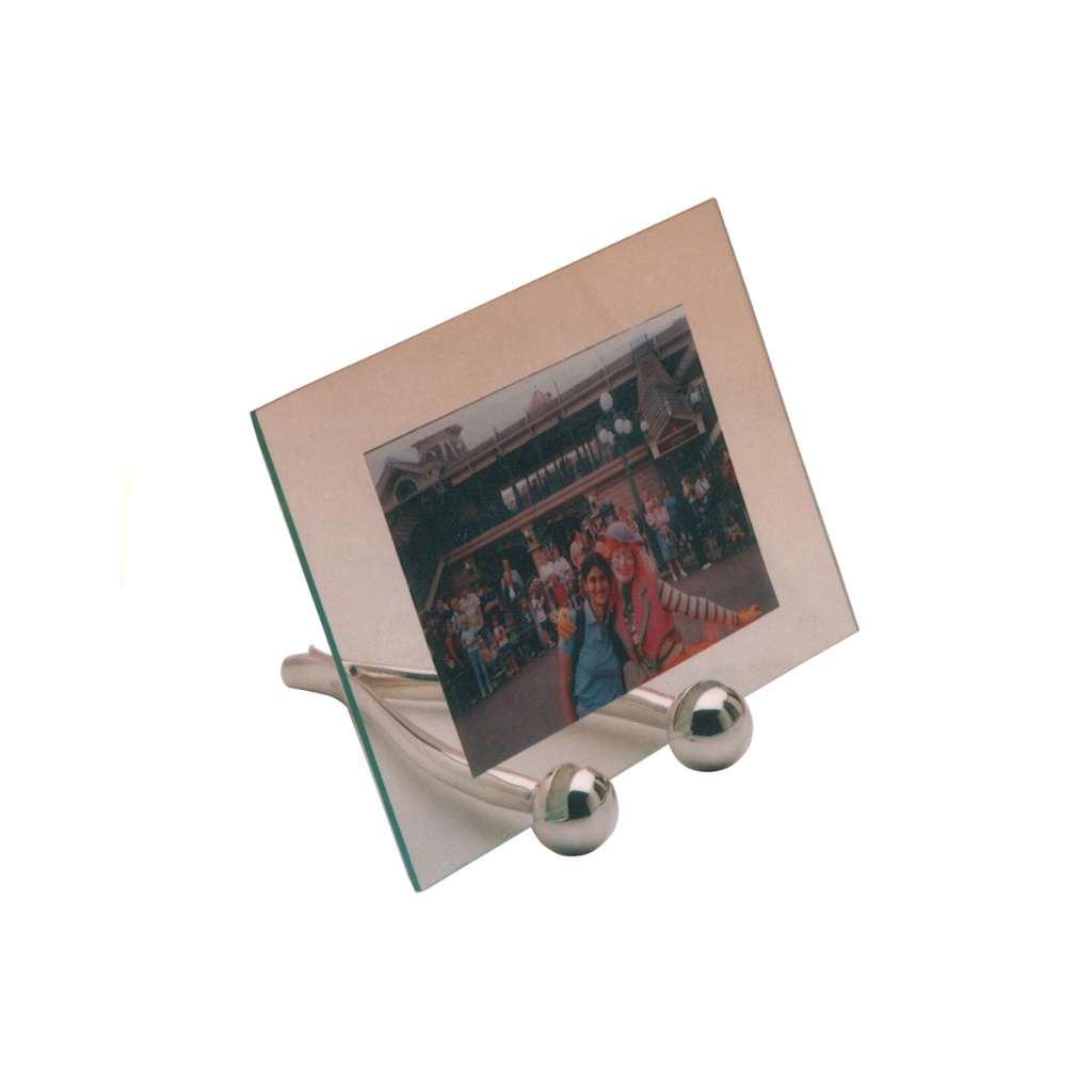 Photo Frame Round Feet is a silver photo frame that stands upright on a pair of rounded ball feet - white background