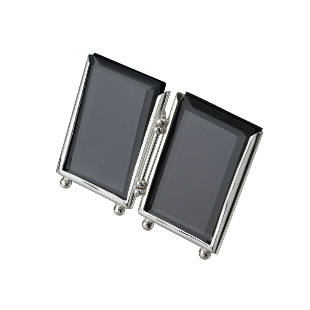 Photo Frame Muse is a silver frame duo joined by a slim ball hinge, so the pair opens flat or angles into a V on a shelf - white background