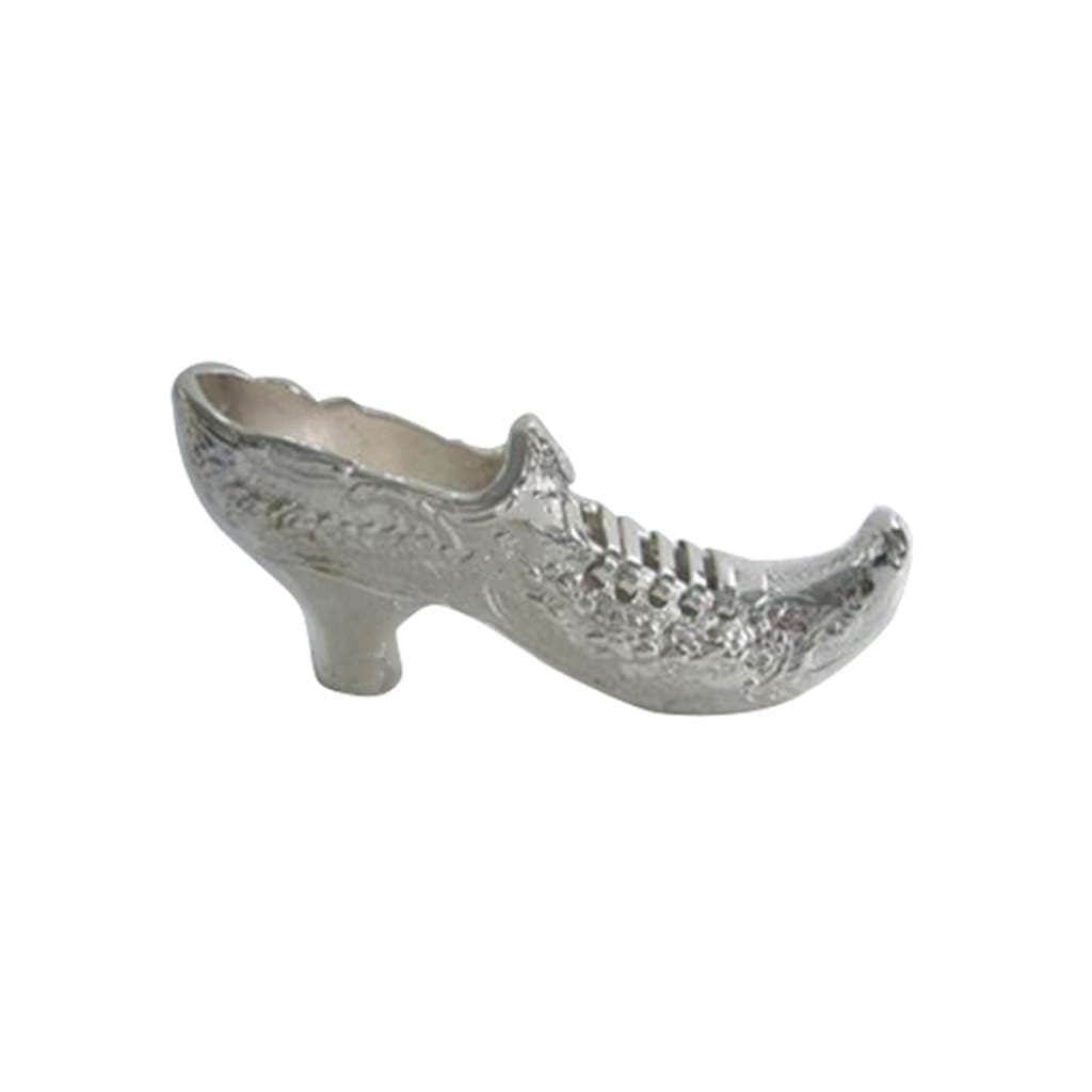 Paper Weight Heels is a silver paperweight in the shape of a heeled shoe, a floral pattern chased across the toe and heel - white background