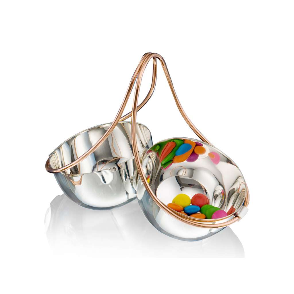 Bowl Nut Fusion joins two mirror-finish silver bowls at an angle beneath a single rose-gold wire handle - white background
