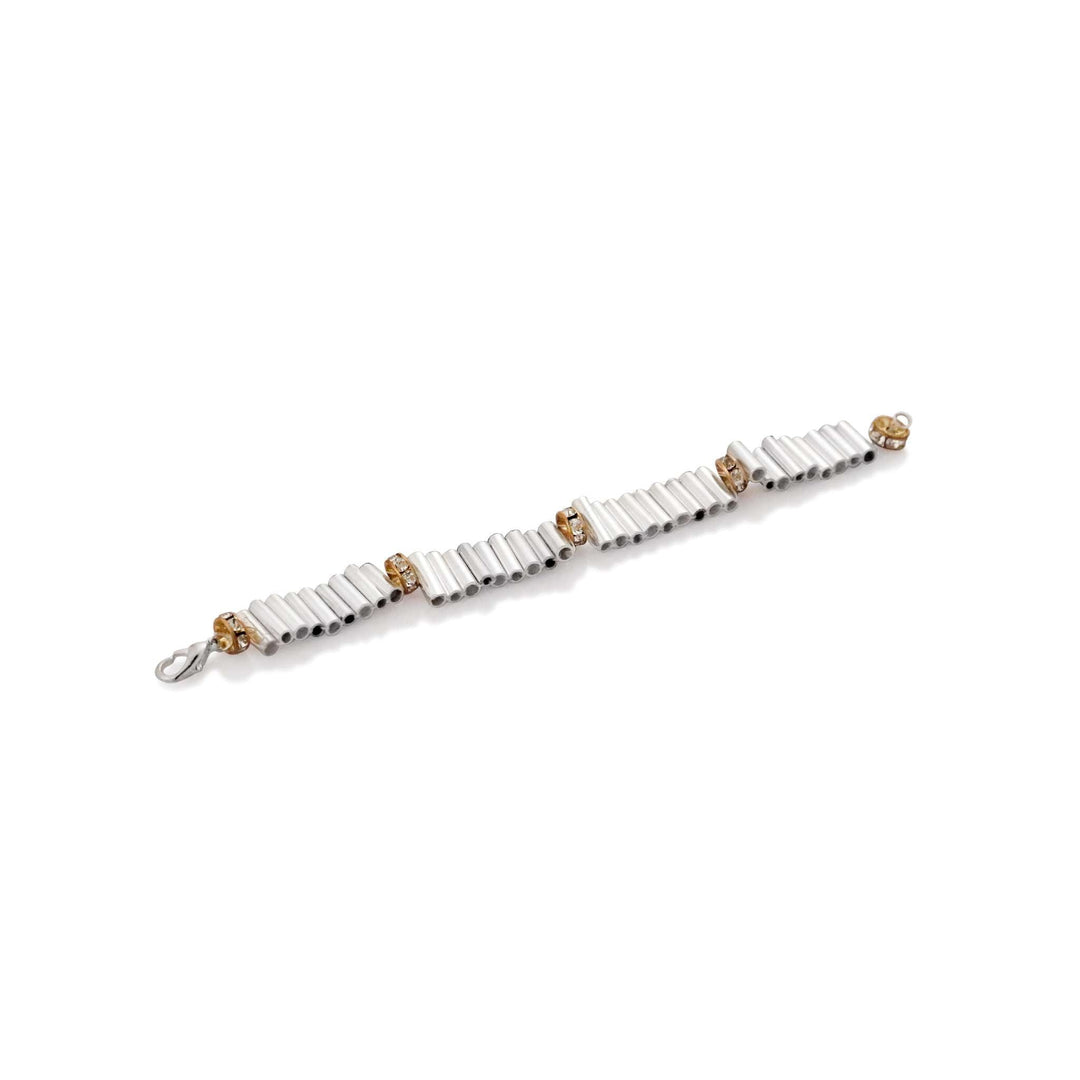 Rakhi Bamboo is a silver rakhi bracelet with bamboo-style tube links and rhinestone rondelles, closed with a lobster clasp. - white background