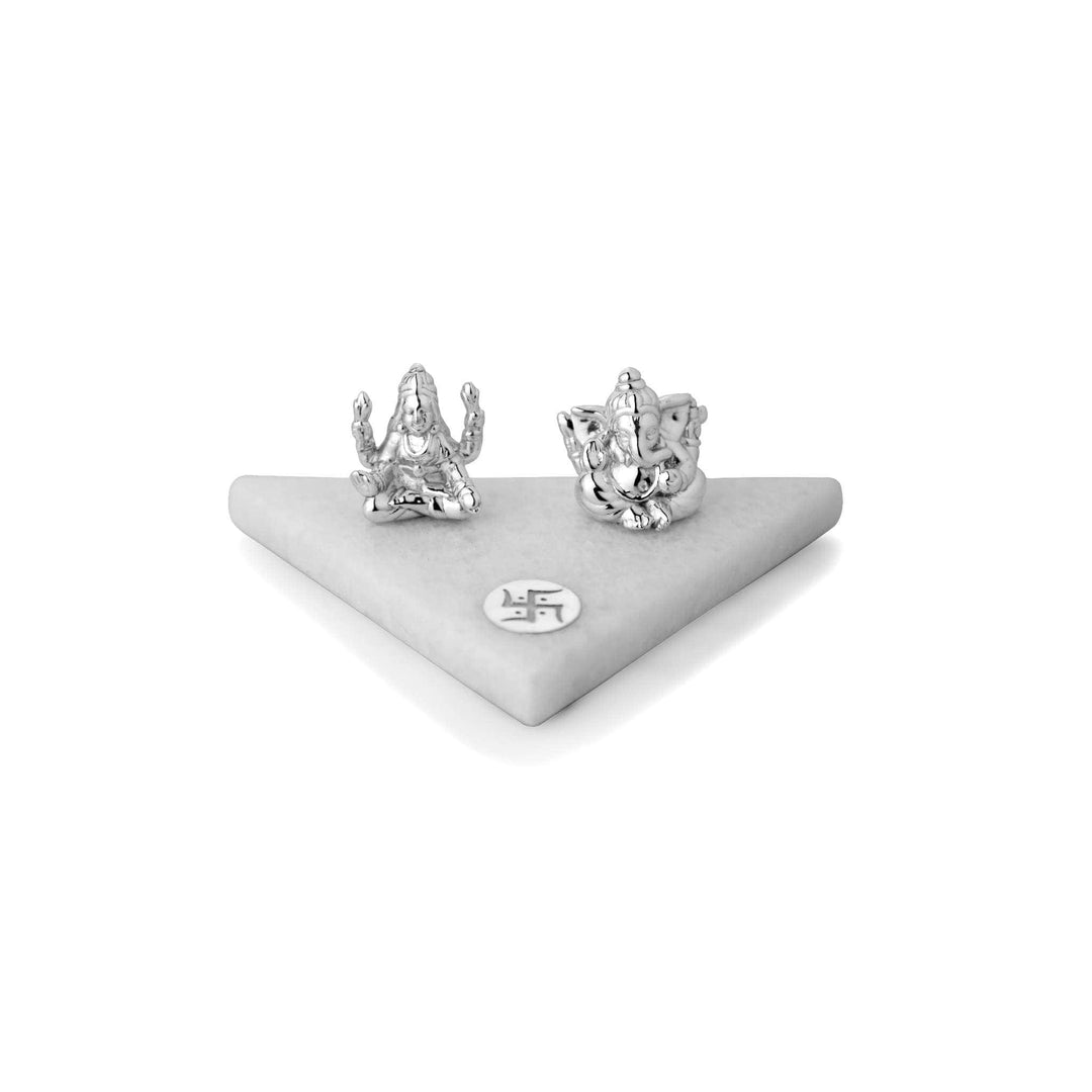 Laxmi Ganesh Triangular Base sits compact sterling silver Lakshmi and Ganesha idols together on a white marble base cut into a clean triangular shape - white background