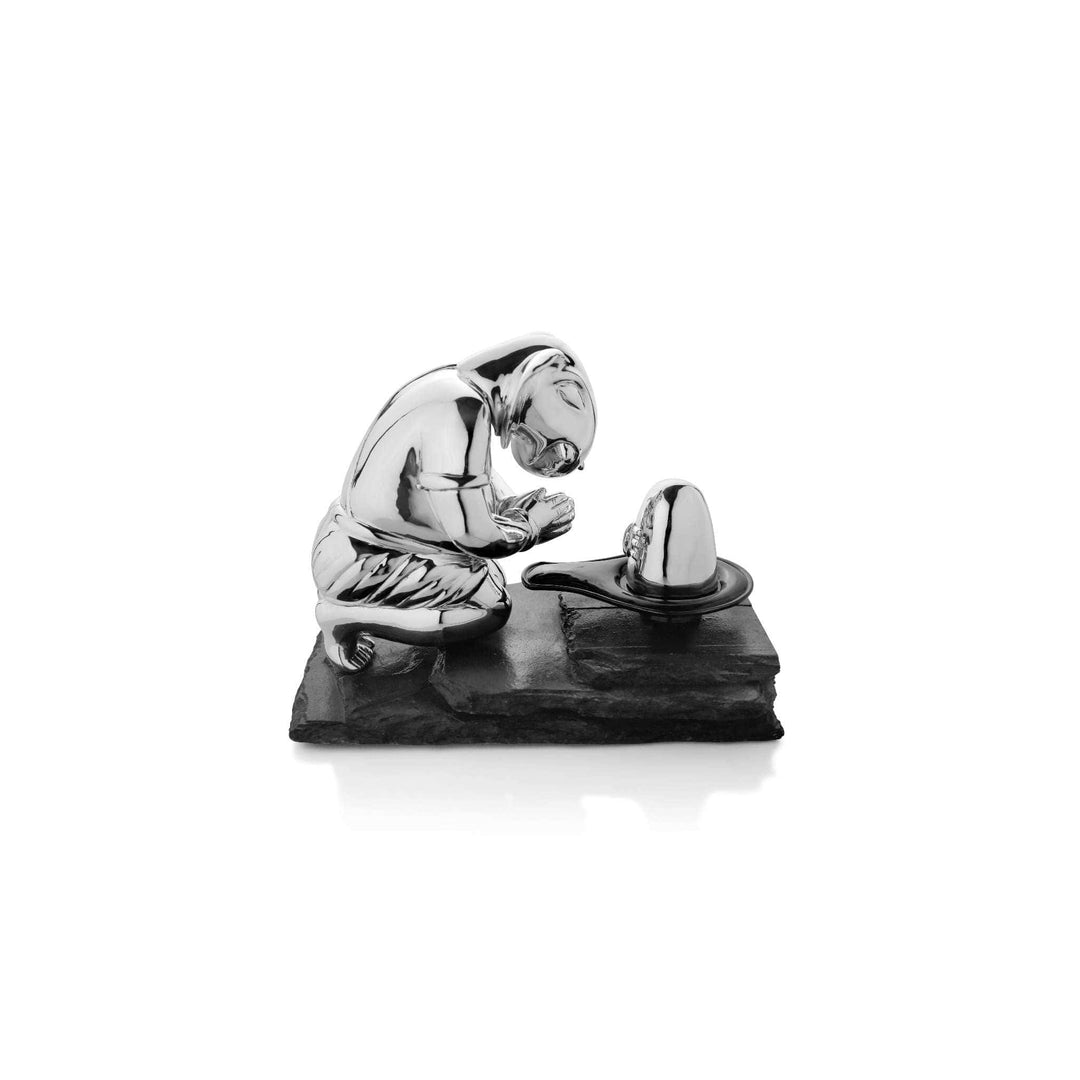Ganesh Bhakt is a sterling silver Ganesha idol kneeling in devotion, hands folded in prayer before a shivling - white background
