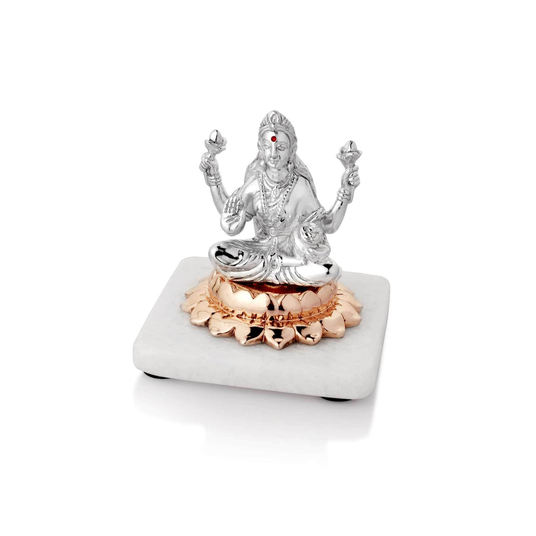 Laxmi On Lotus is a sterling silver Lakshmi idol seated on a copper lotus base - white background