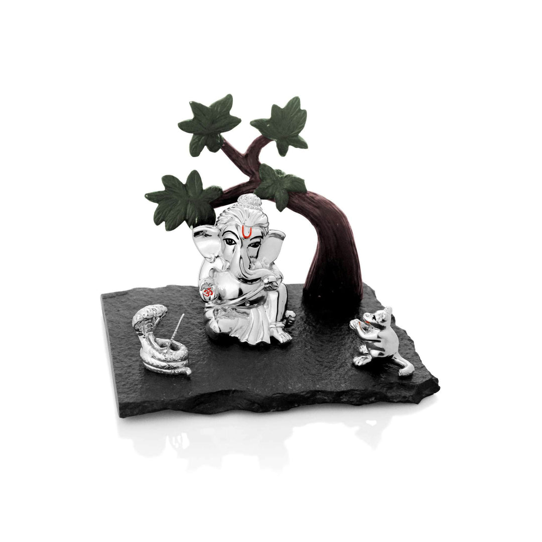 Ganesh Bodhi sets a sterling silver Ganesha idol beneath an enamelled bodhi tree with green leaves and a dark branch arching overhead - white background