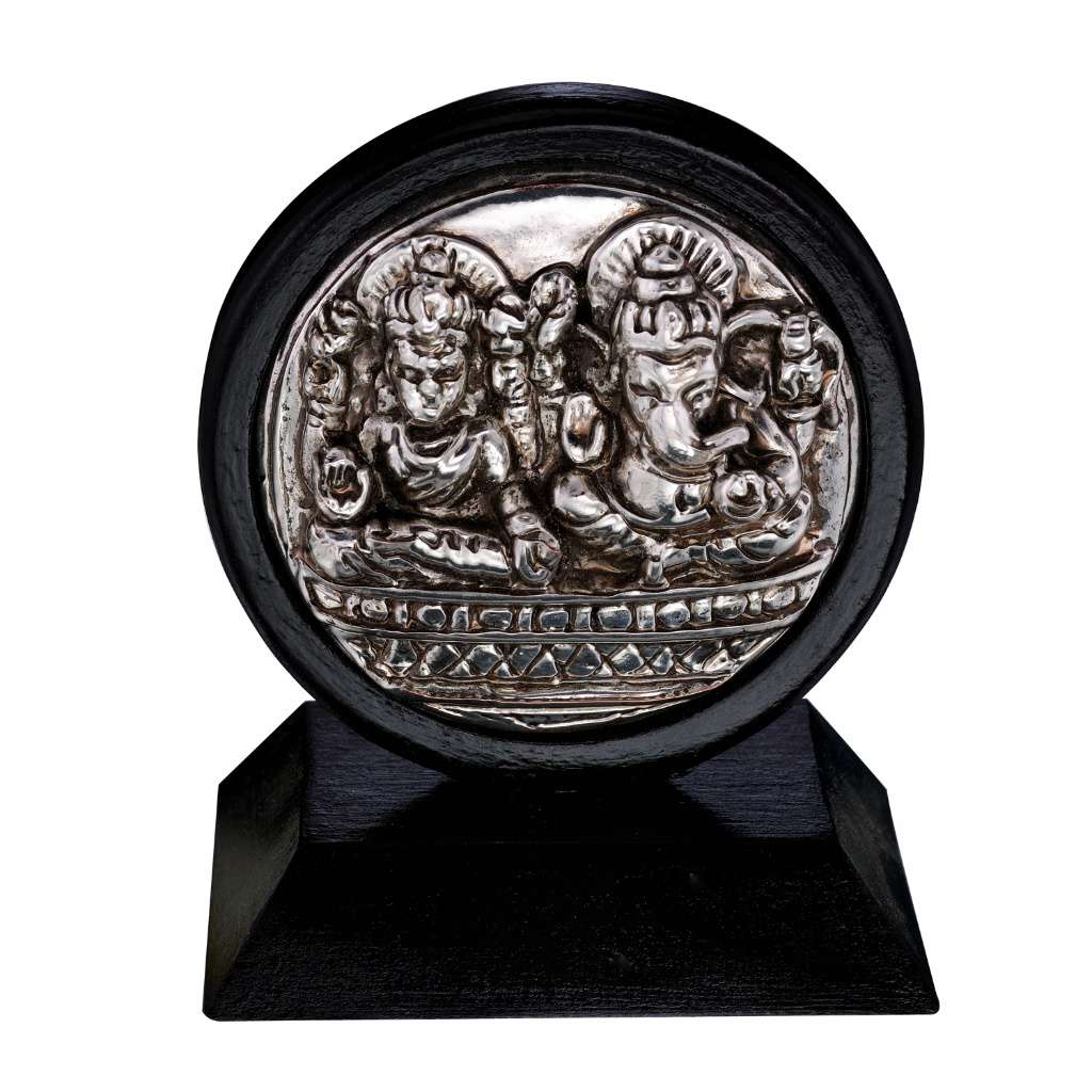 Laxmi Ganesh Table Frame is a sterling silver frame built around a medallion cast with a Lakshmi Ganesha idol in relief - white background