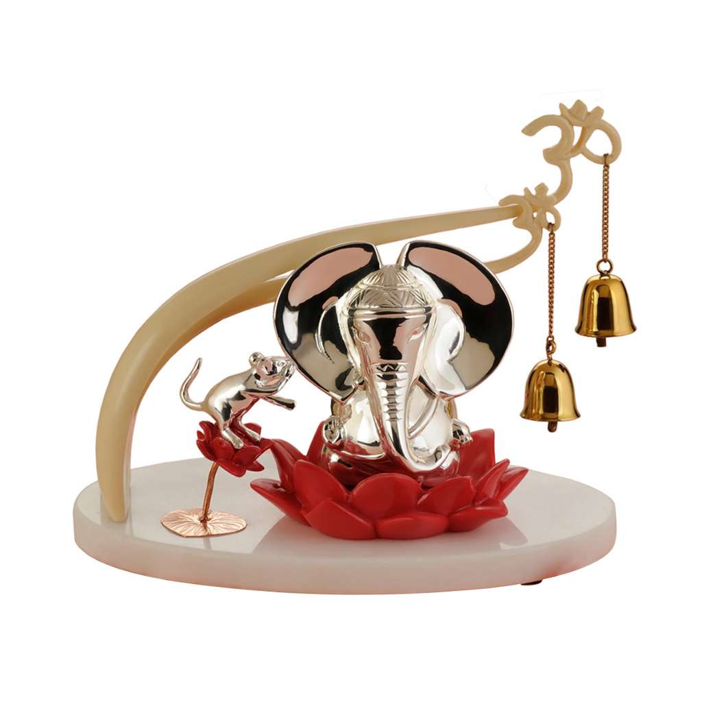Ganesh Shrota sets a silver Ganesha on a bright red lotus flower, beneath a curved ivory-toned arch - white background
