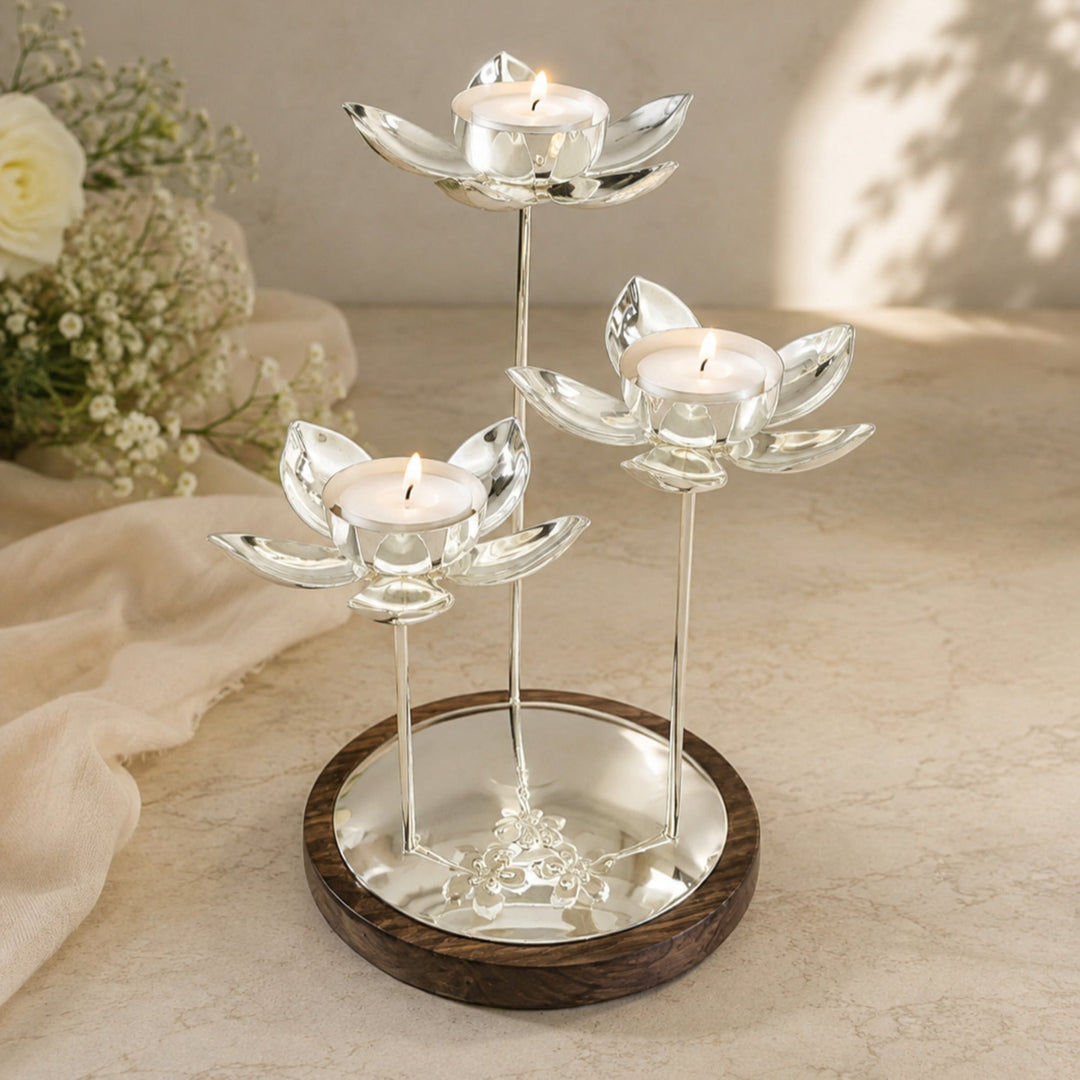 Lotus Centerpiece, a silver tealight holder with three lit lotus blooms