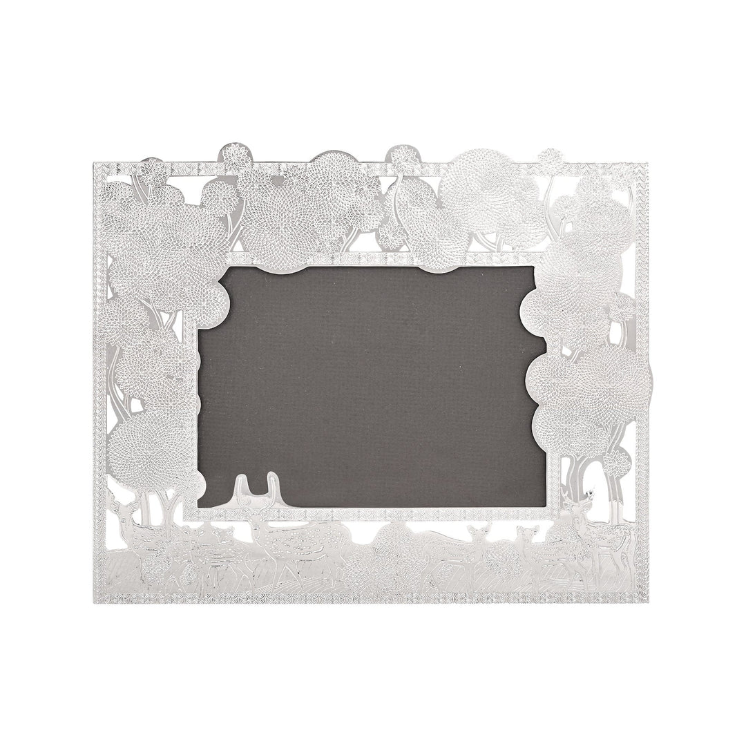 Photo Frame Deer Story is a silver frame that runs clustered trees and foliage along the top of its scalloped border - white background