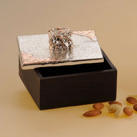 Box Desire is a silver box with a sculptural knob set into a warm walnut-toned wood body, ready to hold rings, cufflinks, or small keepsakes – Large