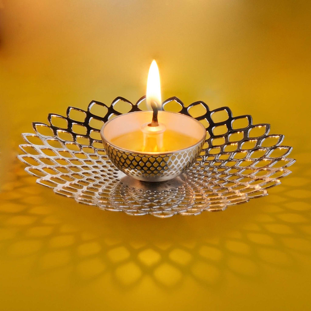 Diya Illusion is a silver diya built around a radiating pierced petal pattern that plays with light and shadow – Double