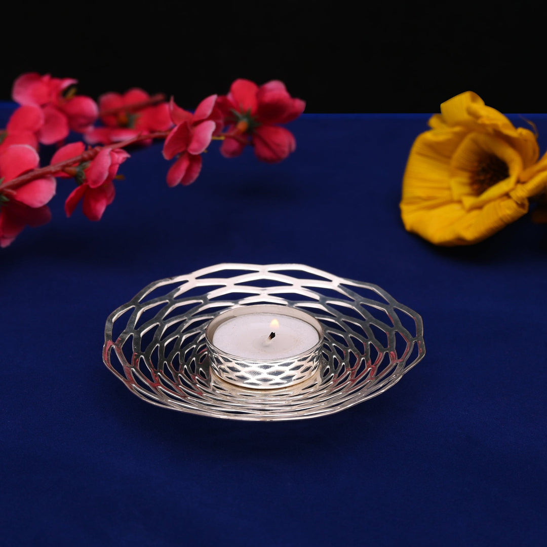 Chakra Votive is a silver candle stand built from a radiating web of wire-like spokes – Large