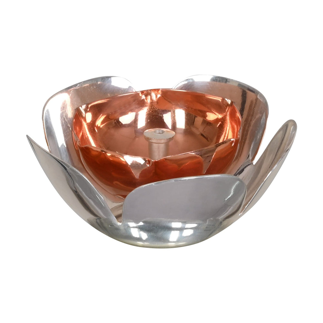 Pushp Diya is a silver diya shaped like an open lotus, with petals curving upward around a warm - white background