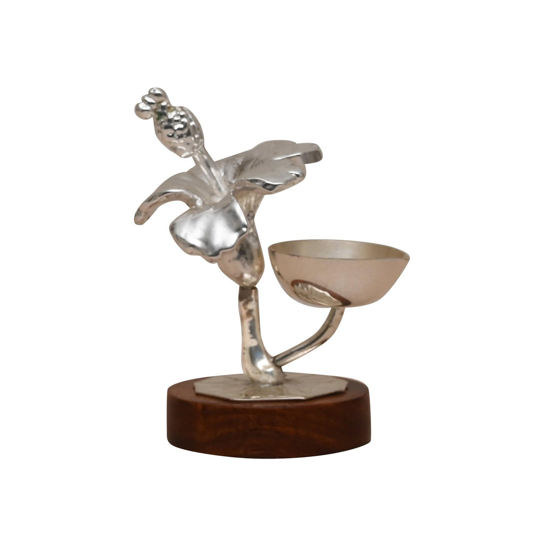 Hibiscus Diya turns a silver diya into a small sculpture, with a hibiscus bloom, leaf - white background