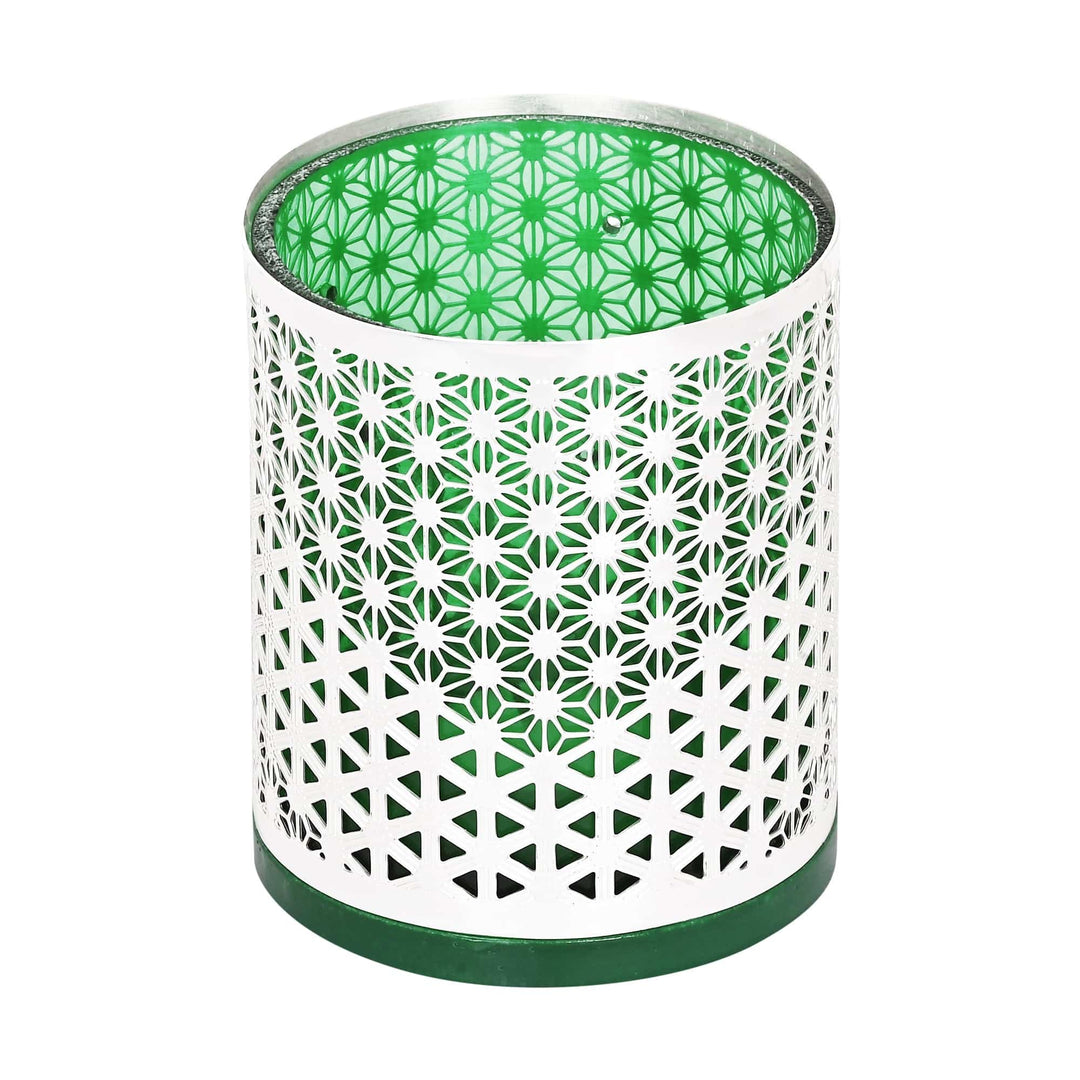 Zen Votive Round is a round silver votive with a pierced lattice body wrapped around a rich green glass liner that glows when lit – Small