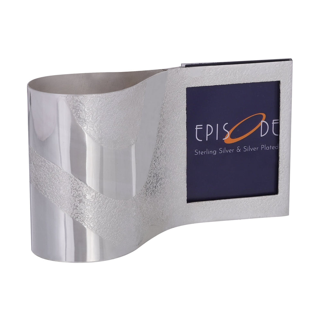 Penstand with Photoframe combines a wave-shaped silver pen stand and a photo frame in one continuous body - white background
