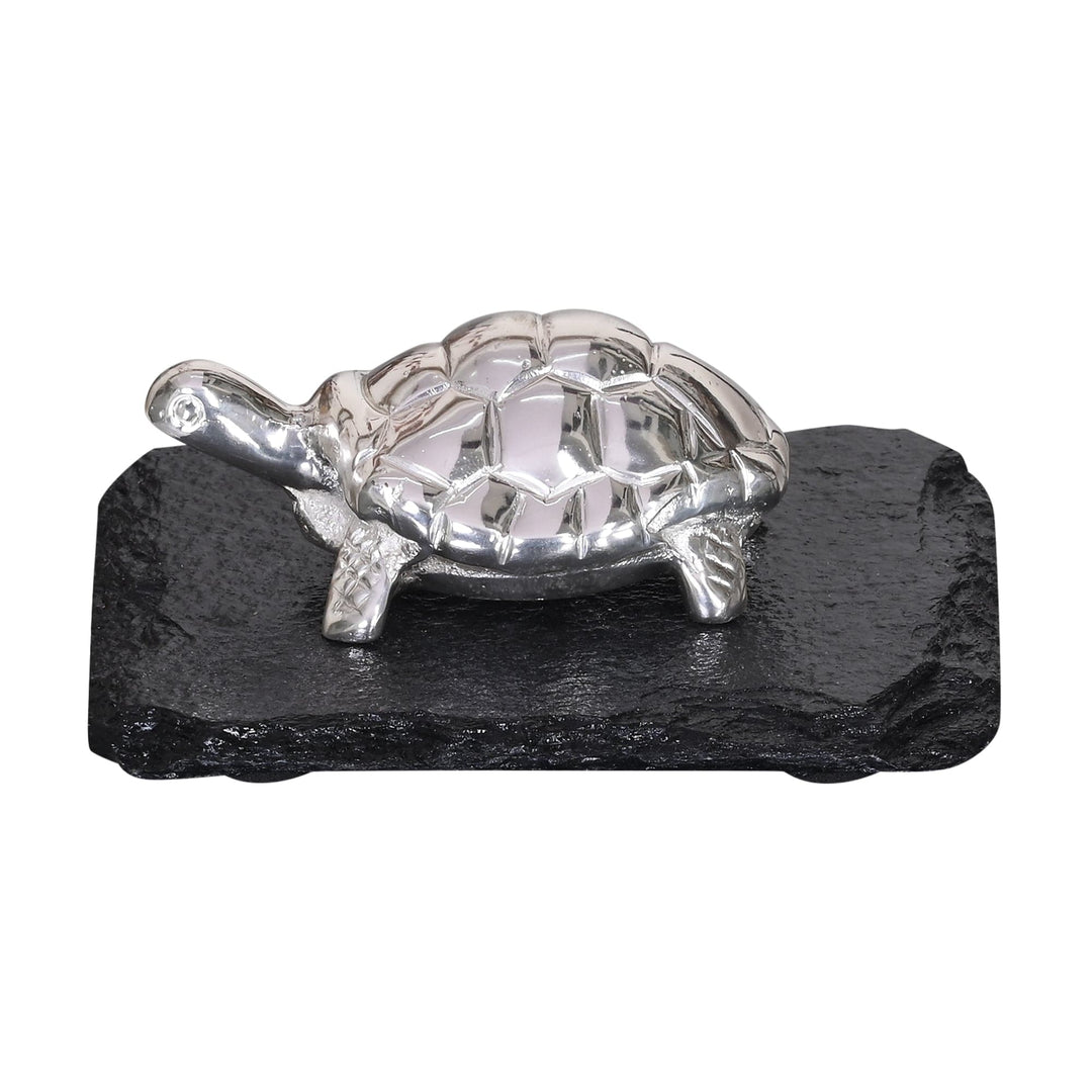 Good Luck Tortoise is a silver figurine cast as a plump, high-shine tortoise, walking across a rough-edged black slate base - white background