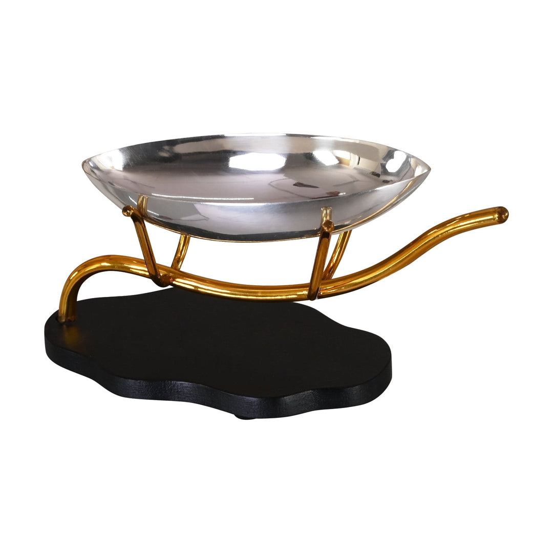 Silver Plated Bowl With Stand lifts a sleek boat-shaped silver bowl above a black wood base on a gold-toned, wave-shaped stand - white background