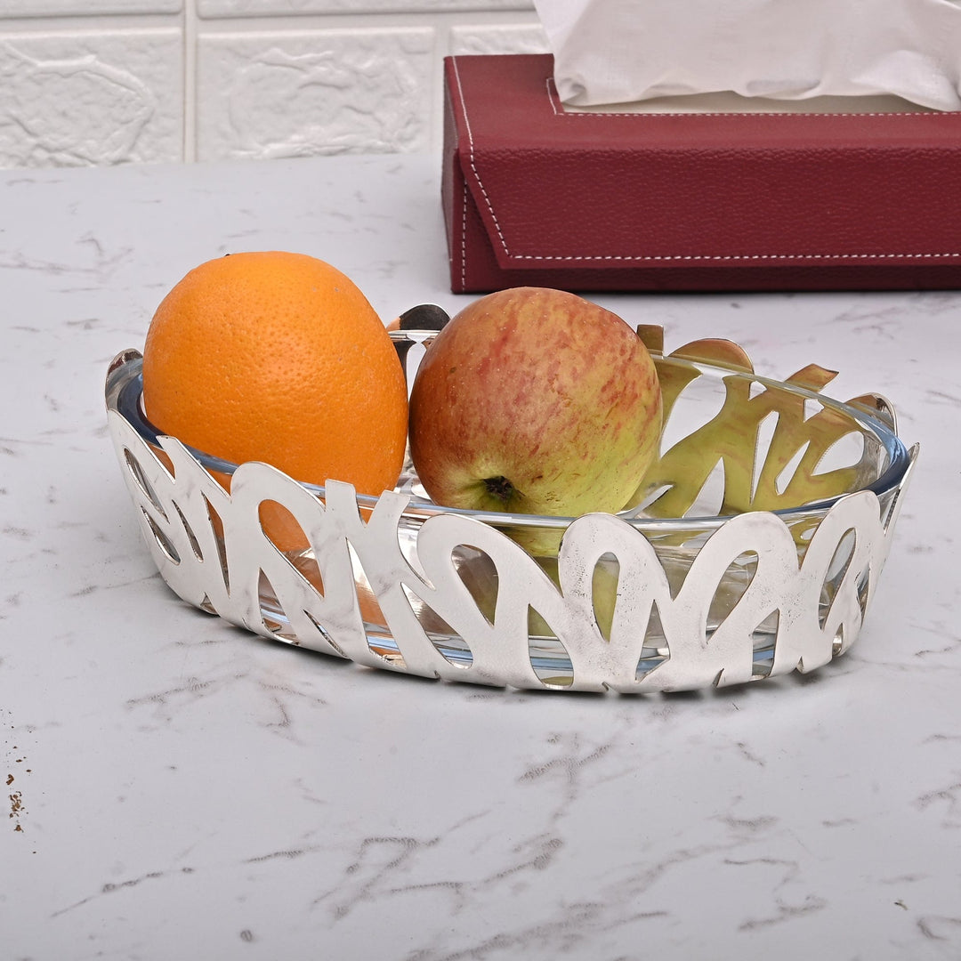 Bowl Oval Graffiti wraps a bold, graffiti-style pierced pattern around a clear glass insert in this oval silver bowl – Large
