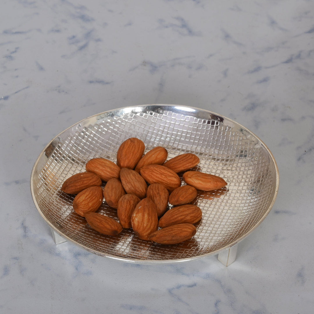Nut Bowl with Legs is a silver nut bowl carrying a finely textured diamond-cut interior that catches the light – Large