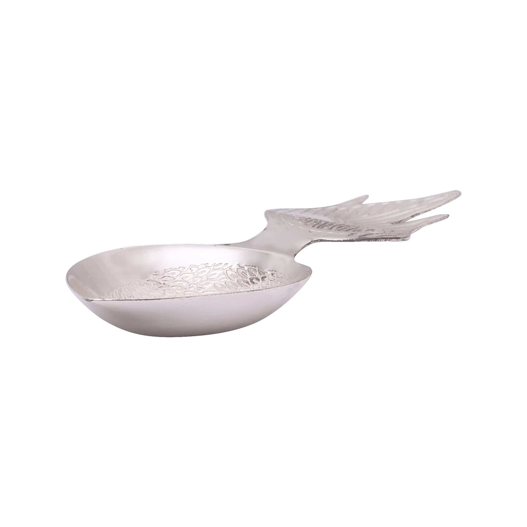 Diya Mayur brings a sterling silver diya to the puja shelf shaped like a peacock in flight - white background