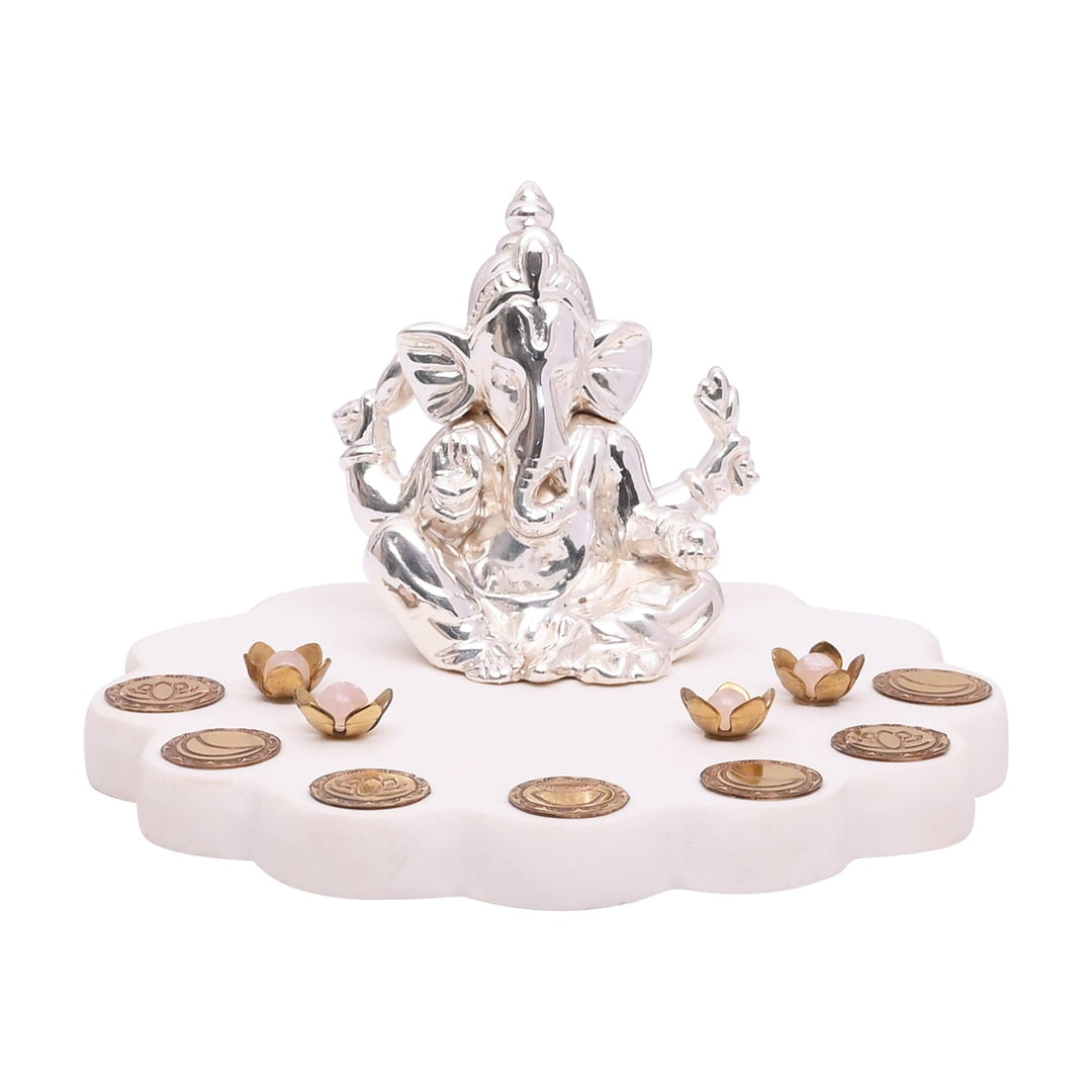 Ganesh Dharti is a sterling silver Ganesha idol, four-armed and seated in blessing - white background