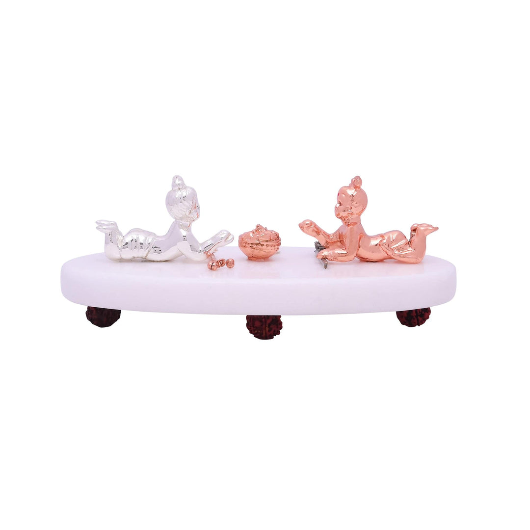 Playful Bal Krishna pairs two sterling silver idols of baby Krishna, one finished in bright silver and the other in a warm rose-gold tone - white background