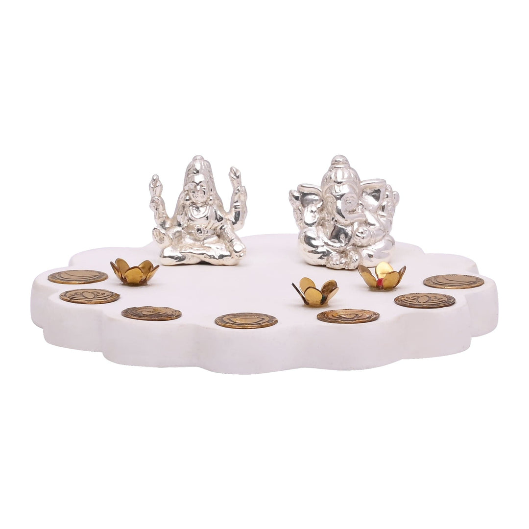 Laxmi Ganesh On Floral Base is a sterling silver idol set holding Lakshmi and Ganesha together on a scalloped, flower-shaped marble base - white background