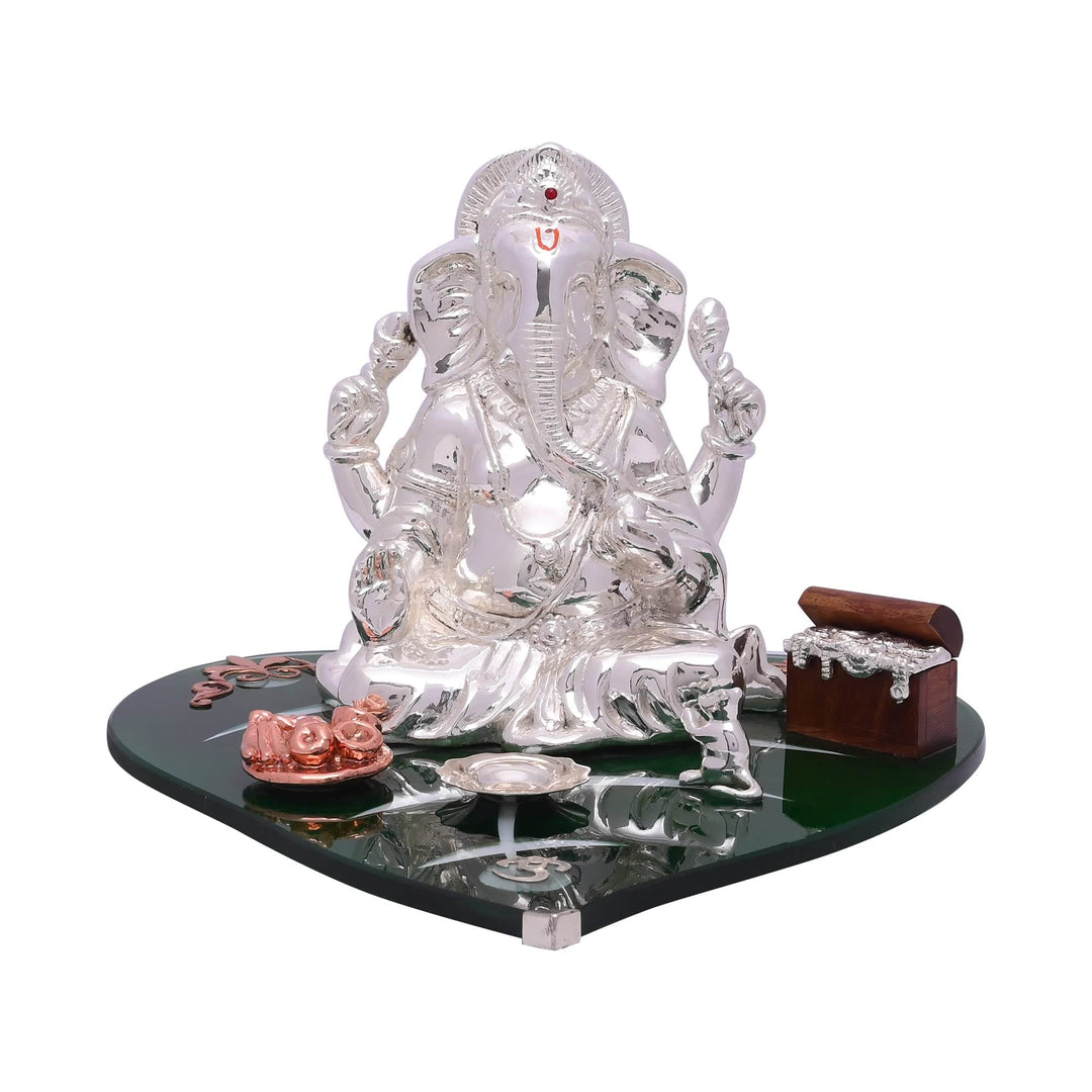 Ganesha Ekavimshati is a sterling silver Ganesha idol with four arms raised in blessing - white background