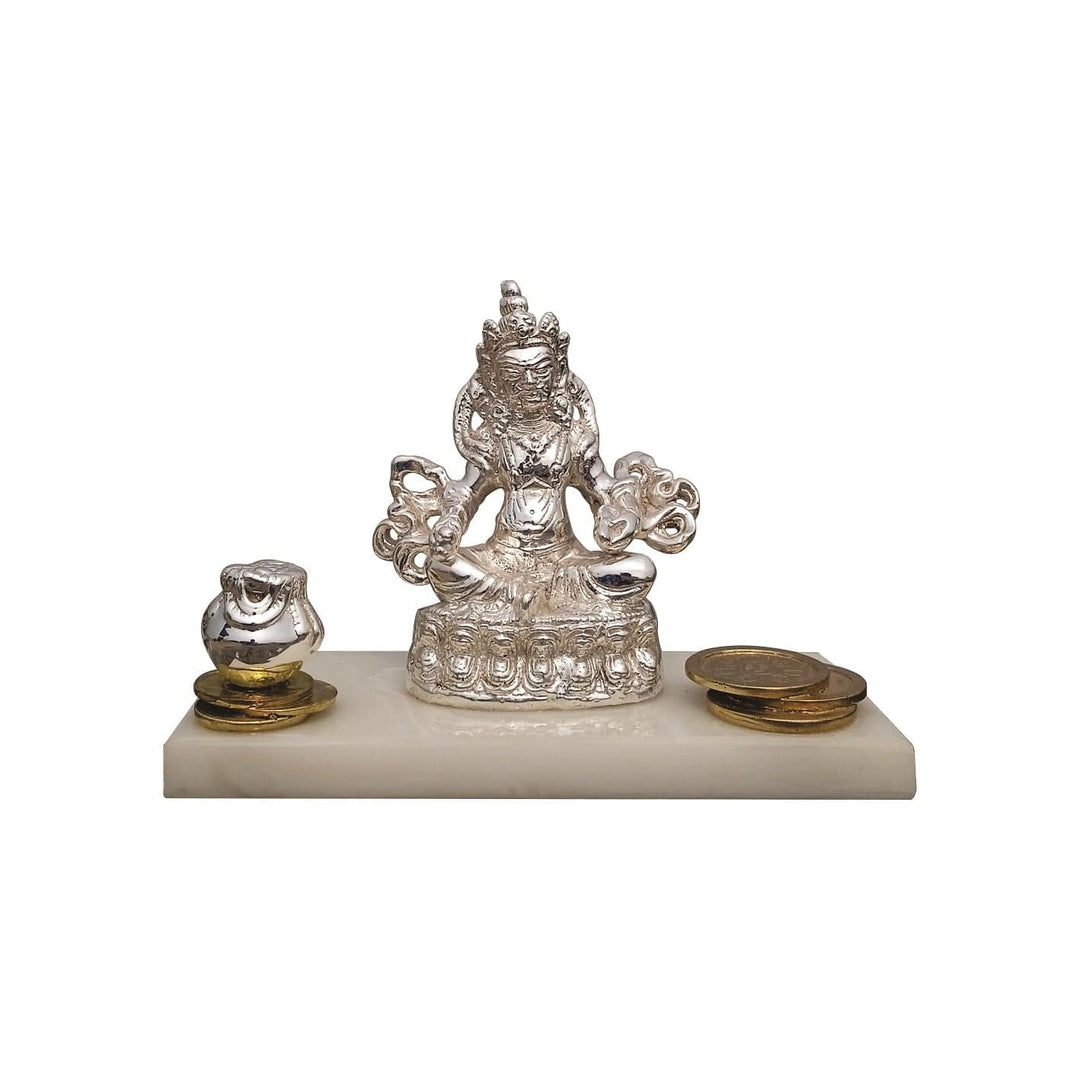 Kuber Mahima presents a sterling silver idol of Kuber seated on a lotus-petal pedestal at the centre of a white marble base - white background