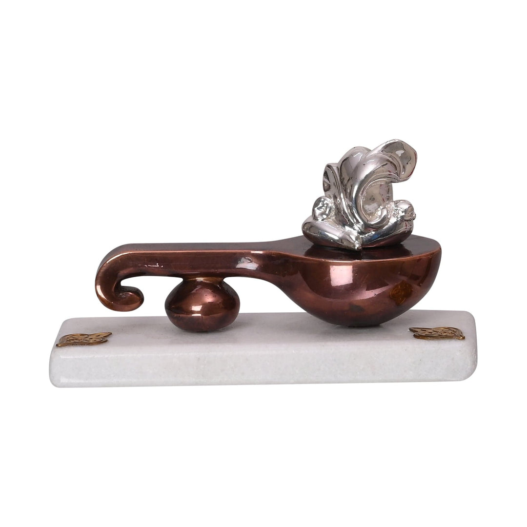 Ganesh With Veena is a silver Ganesha idol carried on a copper-toned veena&