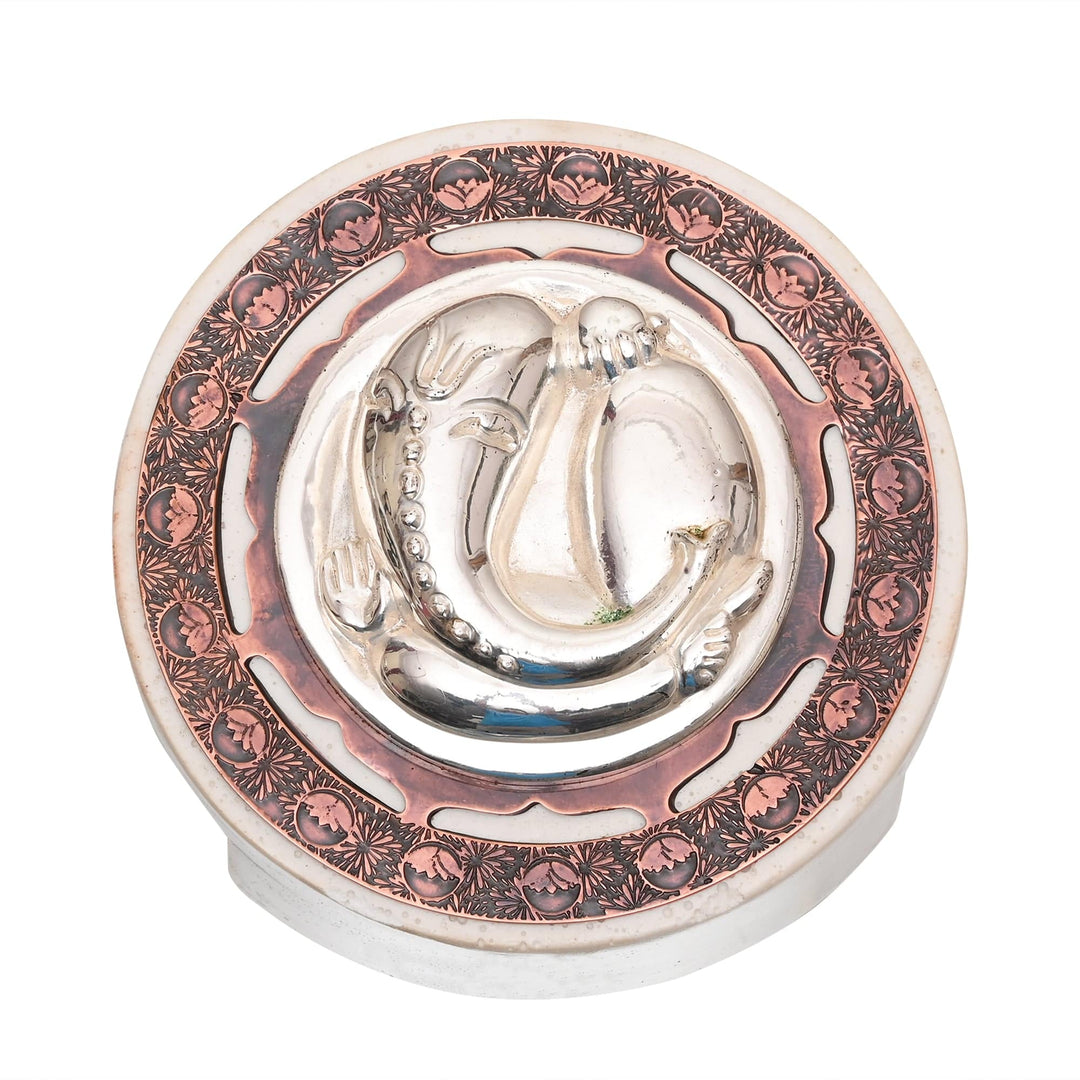 Ganesh Coin On Base gives this silver Ganesha idol a round coin form - white background