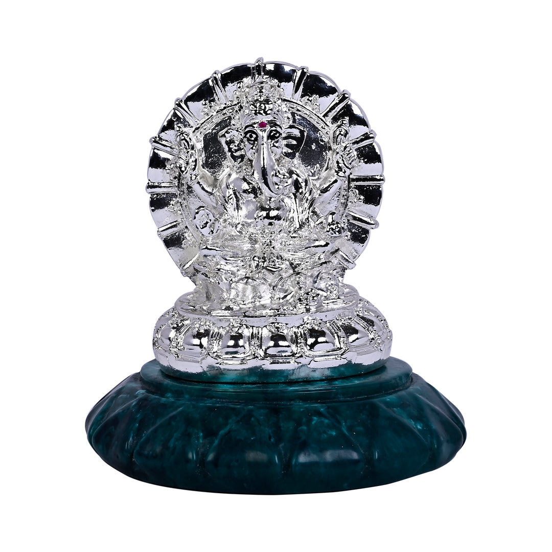 Ganesha Sumukha is a silver Ganesha idol shaped like a medallion - white background