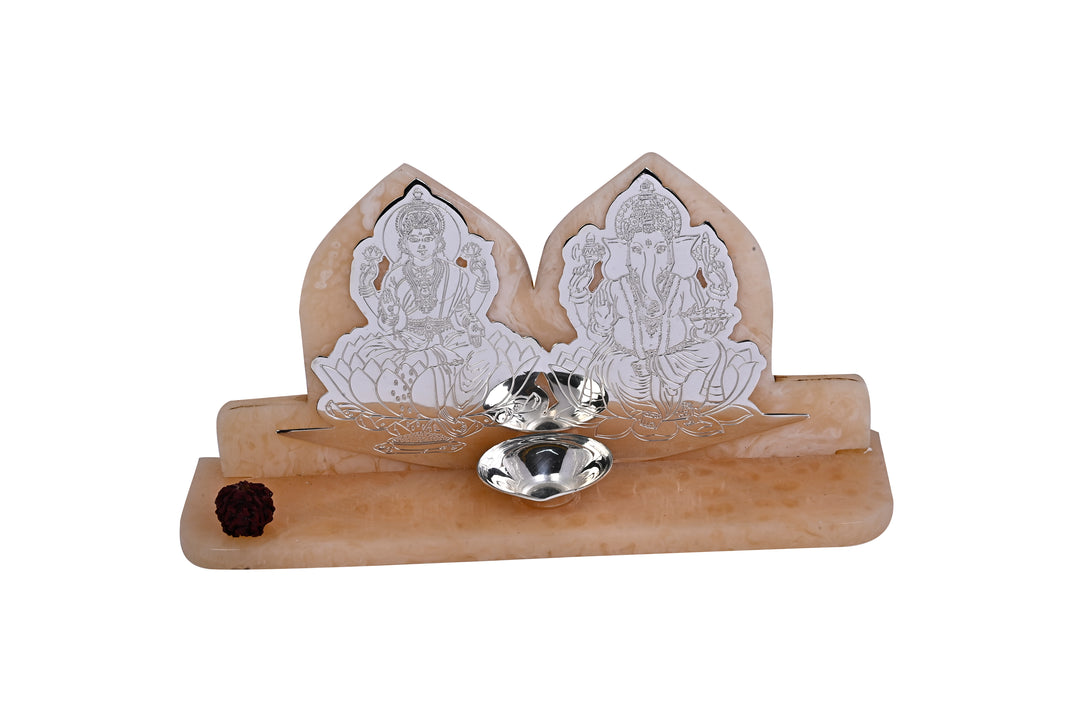 Laxmi Ganesh Dhan Vinayak is a silver idol with Lakshmi and Ganesha appearing as engraved silhouettes - white background