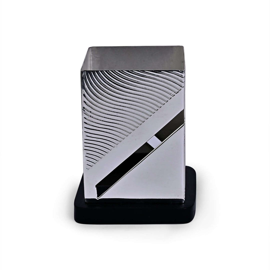 Fluid Pen Stand is a silver pen stand carrying the same fluid, wave-textured surface as the rest of the Fluid desk range - white background