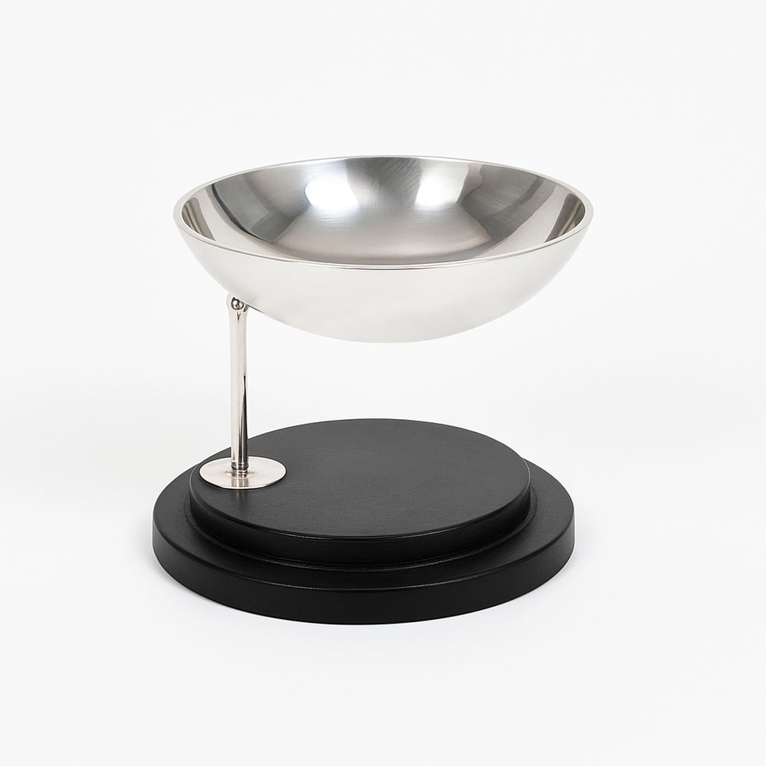 Swinging Nut Bowl balances a hemispherical silver bowl on a slim stem that pivots on a ball joint - white background