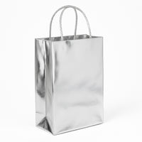 Tote Bag is a metallic silver-tone gift bag with sturdy braided cord handles and a flat, stable base - white background