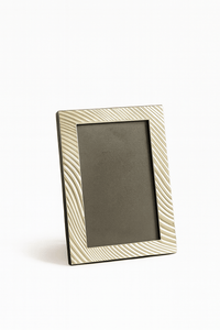 Fluid Photo Frame traces soft diagonal lines in a rippling wave pattern across the border of this silver frame - white background