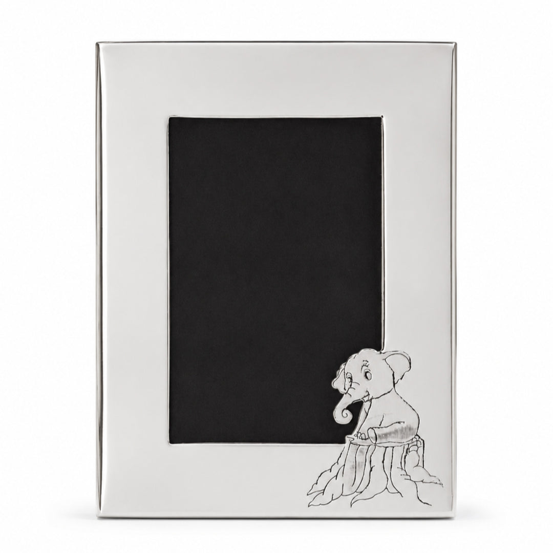 Elephant Photo Frame is a silver photo frame with a plain mirror-polished face and an embossed elephant calf on a tree stump at the lower right - white background